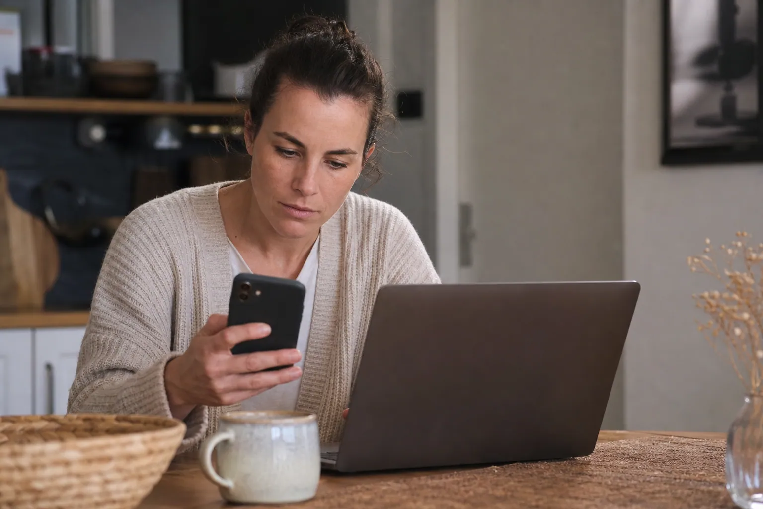 Parent français vérifiant une offre de réduction sur un ordinateur portable à la maison.