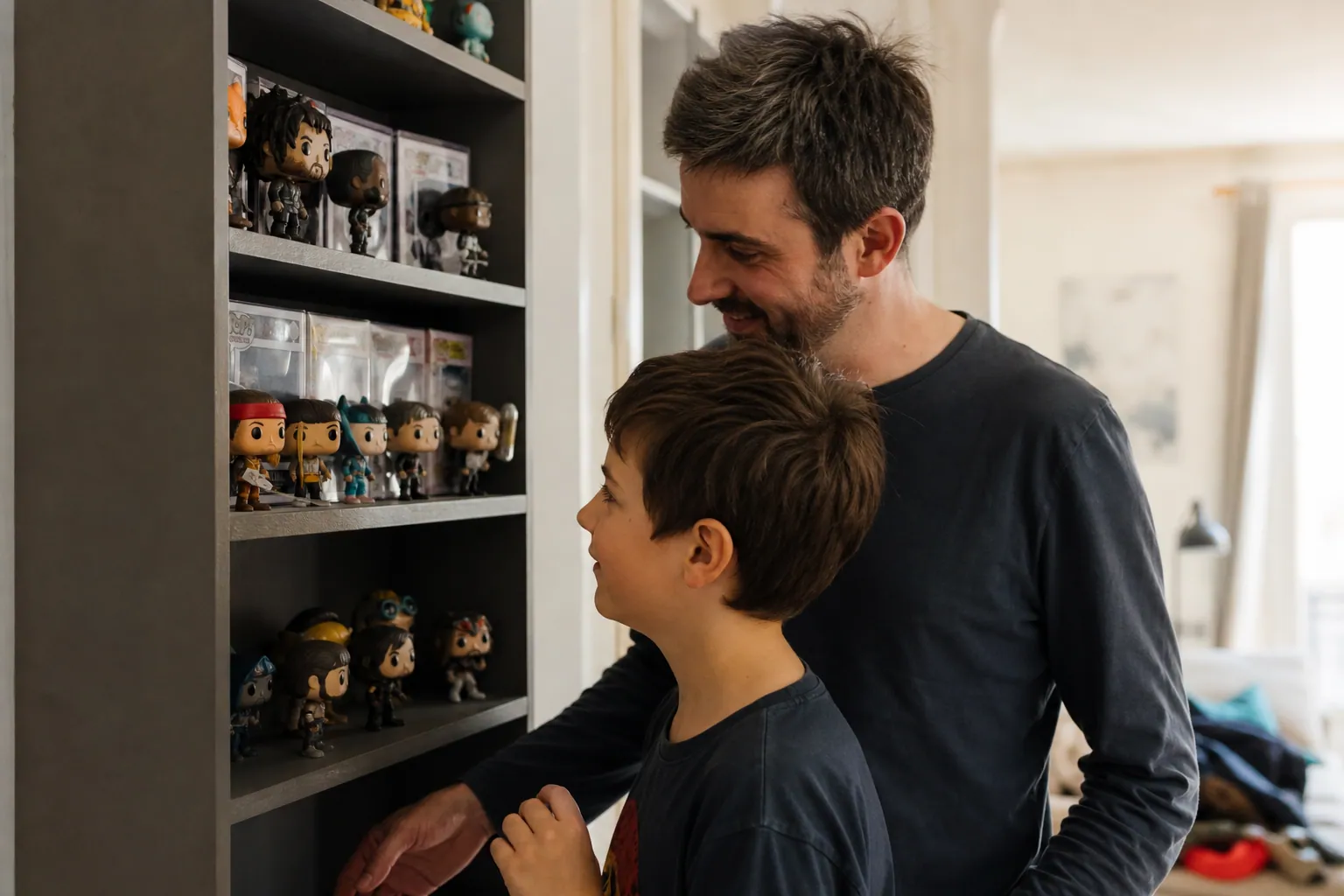 Parent et enfant devant une étagère de figurines Pop dans un salon lumineux.
